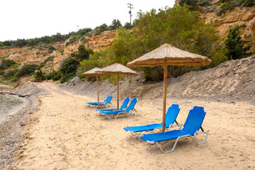 Sun loungers on sandy Limnionas beach. Kos island, Dodecanese, Greece