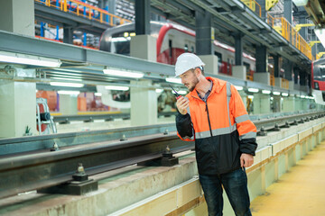 Railway maintenance engineers check readiness in the locomotive repair shop.