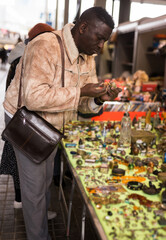 Man looking at used items at a flea market
