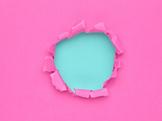 Ripped pink paper with hole in the center