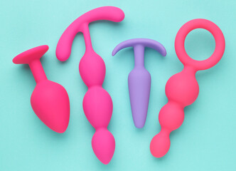 anal plugs and dildo sex toys over turquoise blue background - 779789158
