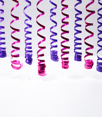 decorative purple streamer ribbons over grey background