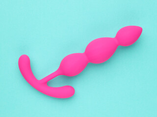 Pink sex toy isolated over turquoise blue background - 779789318
