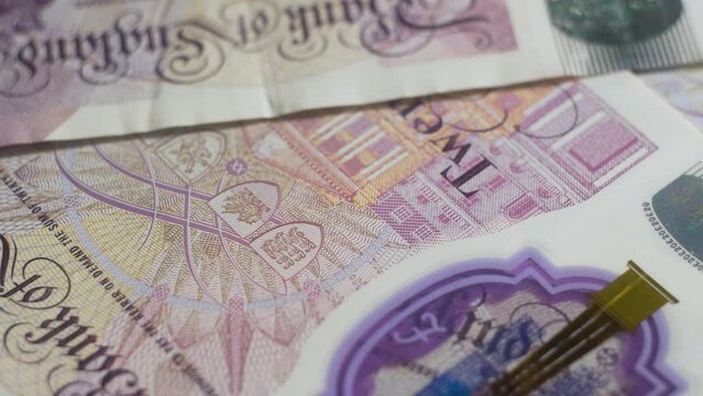 360 degree rotating showcase macro shot of Banknotes english pounds front sides footage. Elements of bill close up. Banknotes english pound, dollar, euro, close up