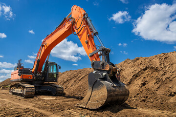A large industrial excavator work on the construction site.  Cloudy sky - 779805758