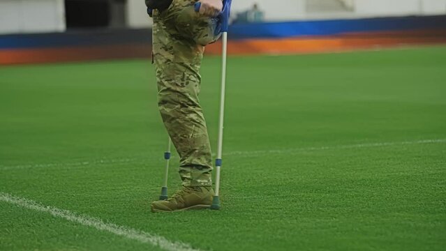 Injured Soldier with Amputated Leg Walking with Crutches