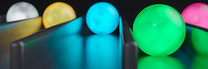 Vibrant colourful neon balls in lanes with one in the lead concept 3d render