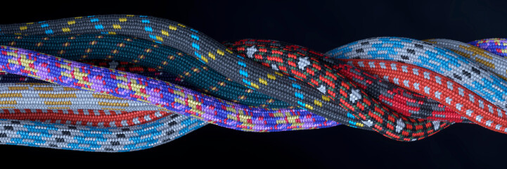Selection of multi-coloured climbing ropes twisted together creating a pattern 3d render