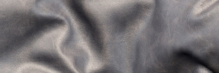 Looking down onto a piece of wrinkled black leather close up 3d render