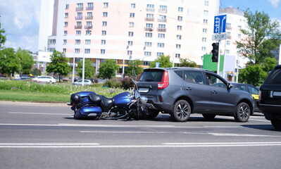Motorcycle crashed into back of car on road. Motorcycle accident concept