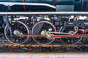 Close-up of wheels of an old retro steam train locomotive