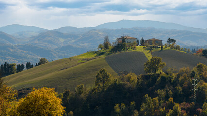 Landscape near Bologna: vineyards, fields, forest and houses on the hill. Bologna, Italy