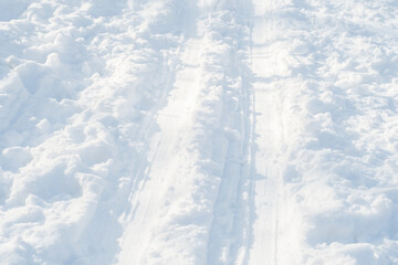 Close-up of ski tracks in the snow. Background on the theme of winter sports.