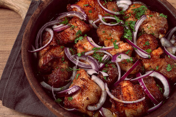 fried meat, pork kebab, ketsi in a clay pan, with red onions and herbs, homemade, no people,