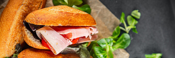 sandwich ham, tomato, green lettuce eating cooking appetizer meal food snack on the table copy space food background rustic