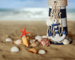 Beach scene with shells, a lighthouse and a starfish