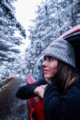 Fototapeta na wymiar Woman's contemplative gaze reflects respect for snowy nature in Sierra de Guadarrama.