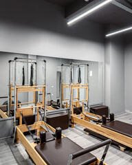 A row of Pilates machines at the gym