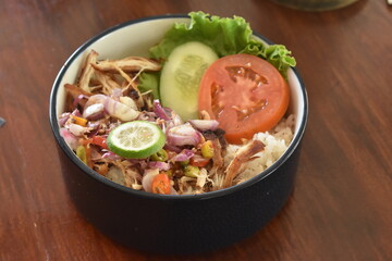 Fried chicken food with delicious and delicious Balinese Indonesian chili sauce. Fresh vegetables make this food even more delicious.