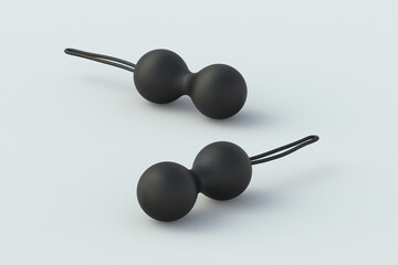 Two black vaginal sex toys on gray background. Geisha balls. Desire and orgasm. Sex shop product. Female masturbation accessory. 3d render