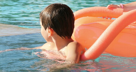 Young boy at the swimming pool candid and casual