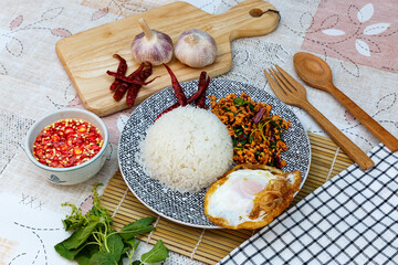 Traditional Thai street food, stir-fried minced pork with basil, chili and garlic, served with fried egg
