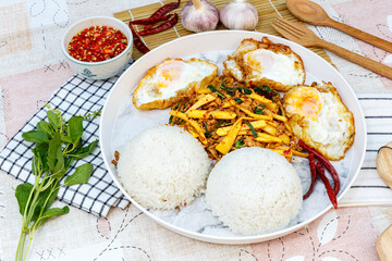 Traditional Thai street food, Jumbo Stir Fried Pork And Bamboo Shoot With Basil with 3 Egg