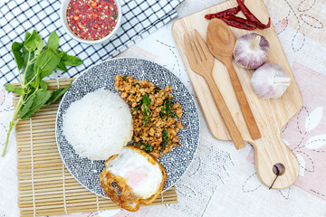 Traditional Thai street food, stir-fried minced chicken with basil, chili, and garlic, served with a fried egg