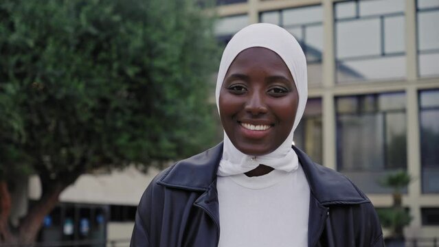 Portrait of young modern muslim woman wearing hijab headscarf in the city - University African student