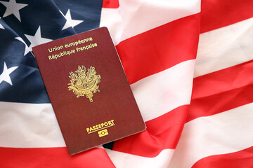 French passport on United States national flag background close up. Tourism and diplomacy concept