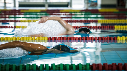 Two female swimmers during a race in the freestyle swim discipline. Concept of front crawl stroke...