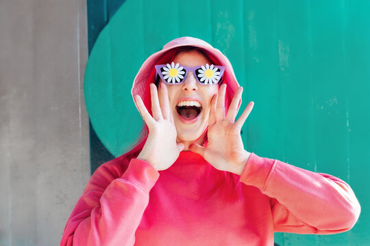 Naklejki Excited emotional loudly shouting, woman in sunglasses with flowers stickers. Playful woman with pink hair,bucket hat calls out everyone's attention. Vanilla Girl. Kawaii vibe. Candy colors.