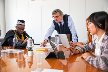 Work meeting in a corporate, the boss explains the work to the employees, multi ethnic group