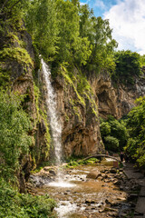 Honey Waterfalls in Kislovodsk, Russia. Water falls into gorge, vertical view of nice canyon and trees in summer. Concept of nature, travel, mountain and forest in Caucasian Mineral Waters. - 779869909