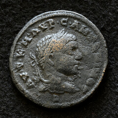 Ancient Roman coin of Emperor Elagabalus, top view of vintage metal money isolated on black background. Concept of old bronze texture, Rome, portrait, Empire, antique - 779869942
