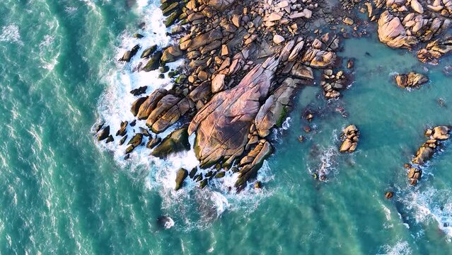 Aerial drone top view of beautiful waves crashing on the rocky island coast, ocean waves and fantastic. Ocean in Vietnam.