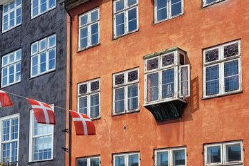 Danish flag and old windows on a colorful building in Copenhagen, Denmark - 779872536