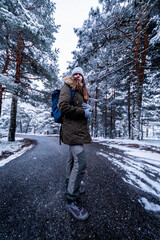 Hiker explores snowy mountainside, respecting the natural ecosystem and weather conditions.