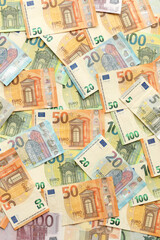 Fototapeta na wymiar Many european euro money bills. Lot of banknotes of european union currency close up