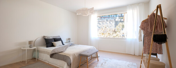Panoramic view of bedroom with large window.