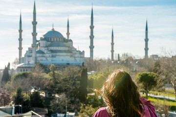 Young woman looking on amazing Blue Mosque in Istanbul, Turkey.