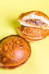 closed burgers in a bun with juicy filling on a yellow background