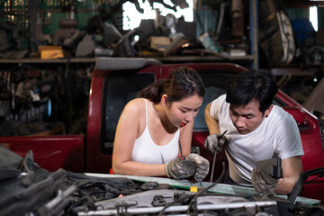 two professional male and female auto mechanic in auto repair shop. technician having automotive...