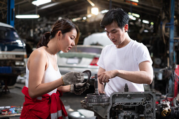 two professional male and female auto mechanic in auto repair shop. technician having automotive...