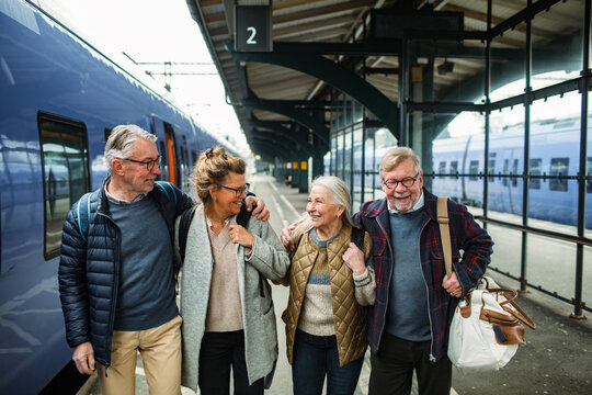 Group of senior people walking together at train station