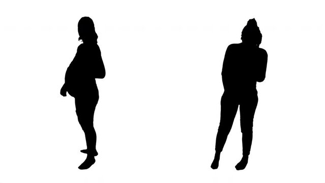 Pregnant Woman Silhouette Cuddles Belly Full Body Shot. Silhouette of a pregnant girl turn around and cuddle her belly. Frontal shot