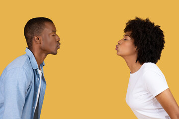 Two people facing each other in profile view
