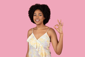 African American woman making OK sign with fingers