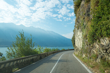 Driving on the winding Gardesana road between Limone and Gargnano, danger of rock falls