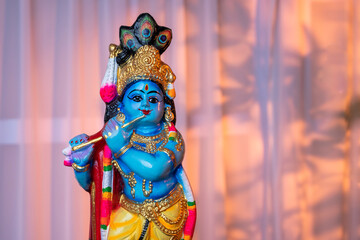 Hindu God Krishna sculpture isolated on white curtain